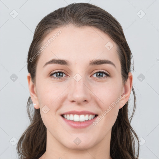 Joyful white young-adult female with long  brown hair and grey eyes