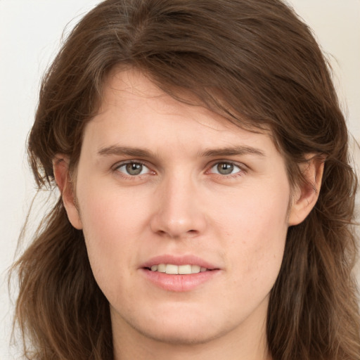 Joyful white young-adult female with long  brown hair and grey eyes