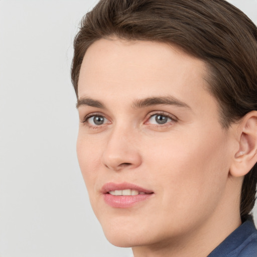 Joyful white young-adult female with short  brown hair and grey eyes