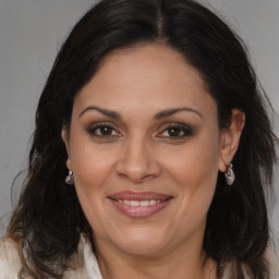 Joyful white adult female with long  brown hair and brown eyes