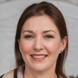 Joyful white adult female with medium  brown hair and brown eyes