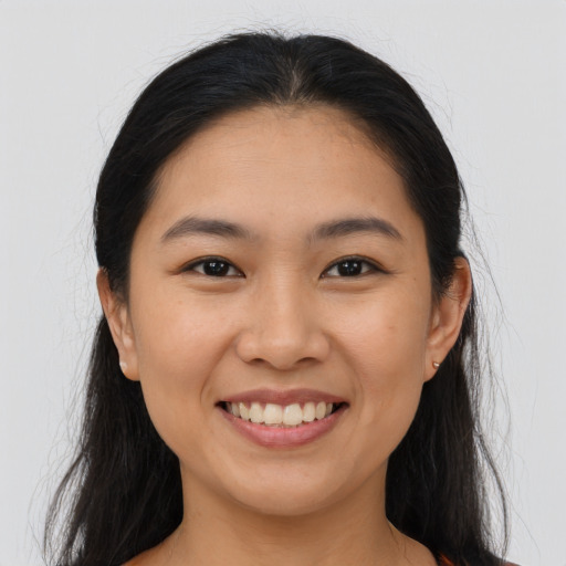 Joyful asian young-adult female with long  brown hair and brown eyes