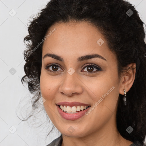 Joyful latino young-adult female with long  brown hair and brown eyes