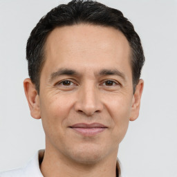 Joyful white adult male with short  brown hair and brown eyes