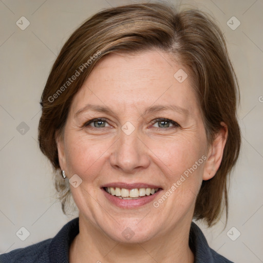 Joyful white adult female with medium  brown hair and grey eyes