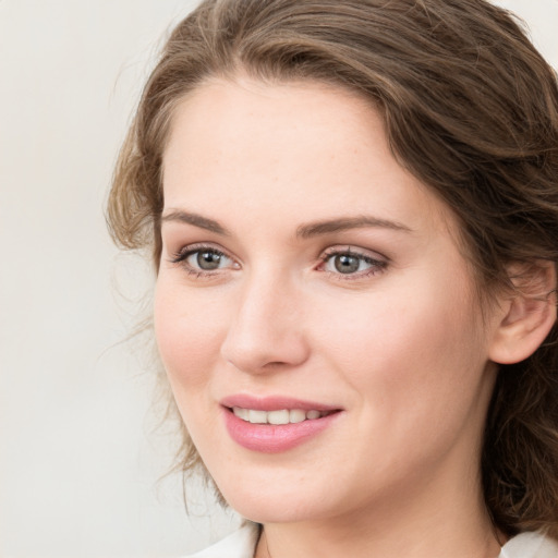 Joyful white young-adult female with medium  brown hair and green eyes