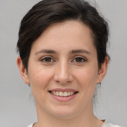 Joyful white young-adult female with medium  brown hair and brown eyes