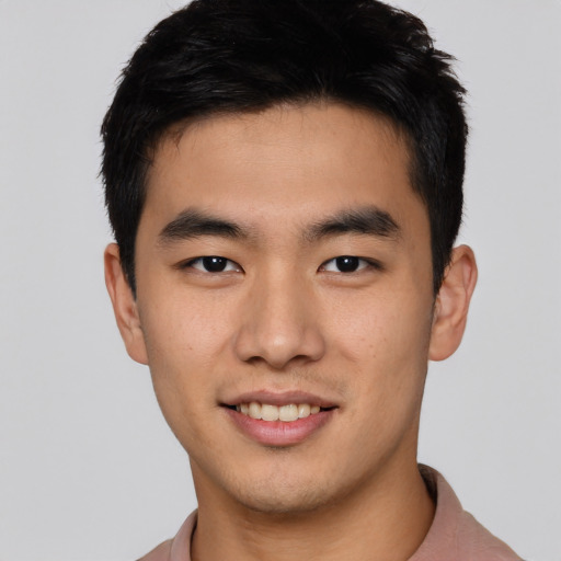 Joyful asian young-adult male with short  black hair and brown eyes