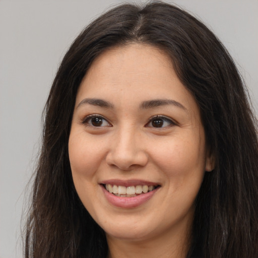 Joyful white young-adult female with long  brown hair and brown eyes