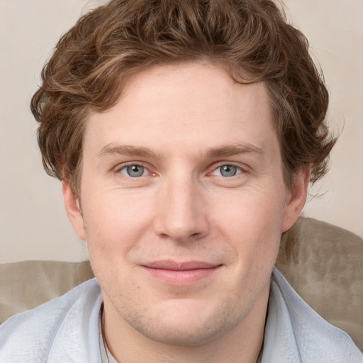 Joyful white young-adult male with short  brown hair and blue eyes