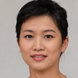 Joyful asian young-adult female with short  brown hair and brown eyes