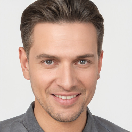 Joyful white young-adult male with short  brown hair and brown eyes