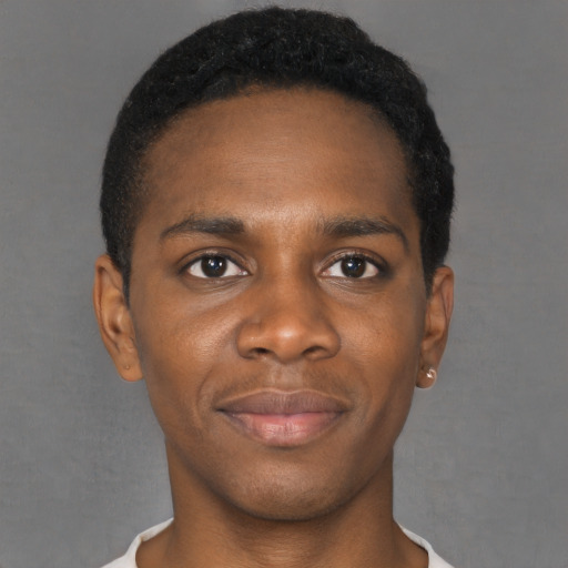 Joyful black young-adult male with short  black hair and brown eyes
