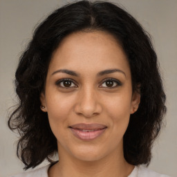 Joyful black young-adult female with medium  brown hair and brown eyes