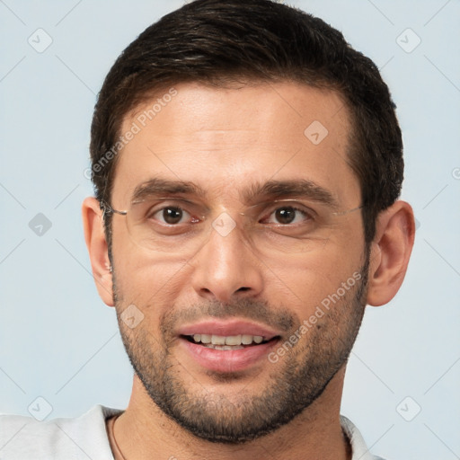 Joyful white adult male with short  brown hair and brown eyes