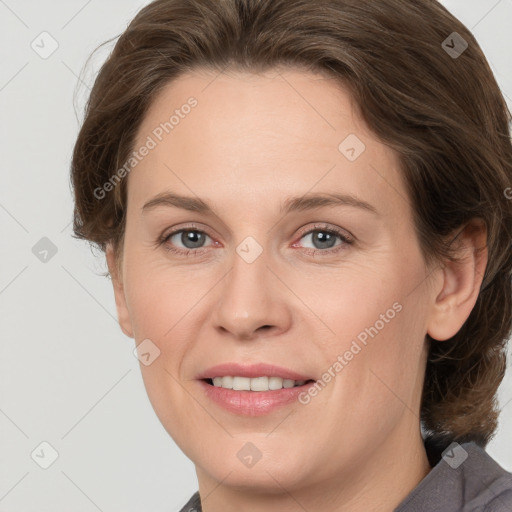 Joyful white adult female with medium  brown hair and grey eyes