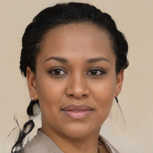 Joyful black young-adult female with short  brown hair and brown eyes