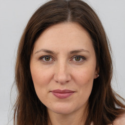 Joyful white adult female with long  brown hair and brown eyes