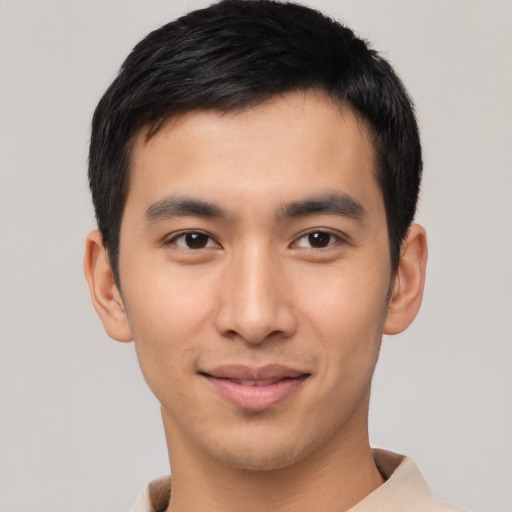 Joyful asian young-adult male with short  brown hair and brown eyes