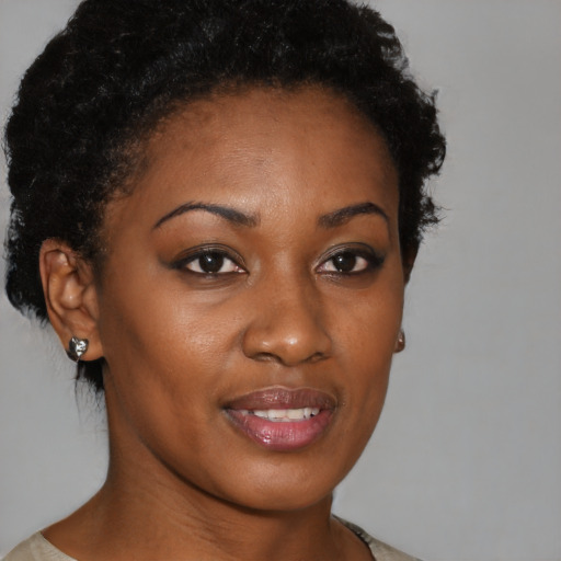 Joyful black young-adult female with short  brown hair and brown eyes