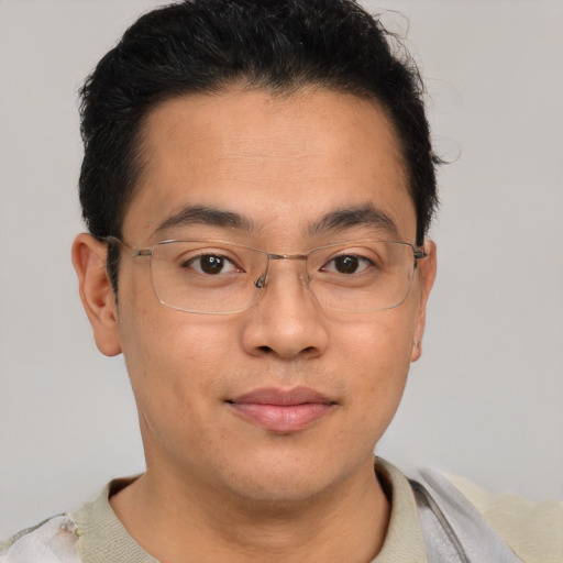 Joyful asian young-adult male with short  brown hair and brown eyes