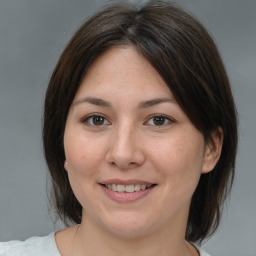 Joyful white adult female with medium  brown hair and brown eyes