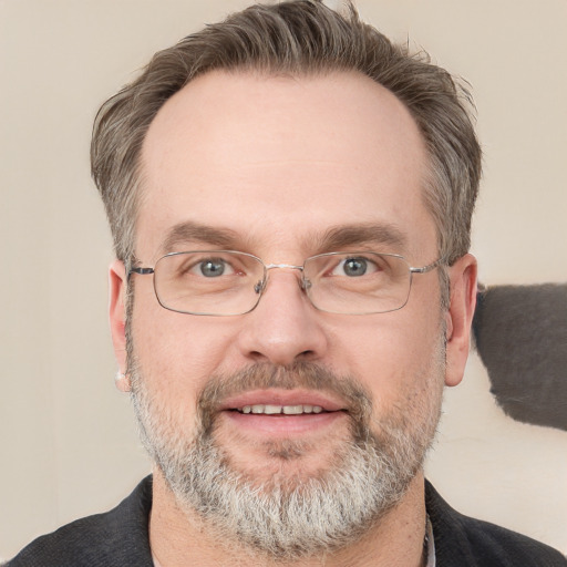 Joyful white adult male with short  brown hair and grey eyes