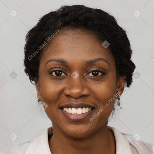 Joyful black young-adult female with short  black hair and brown eyes