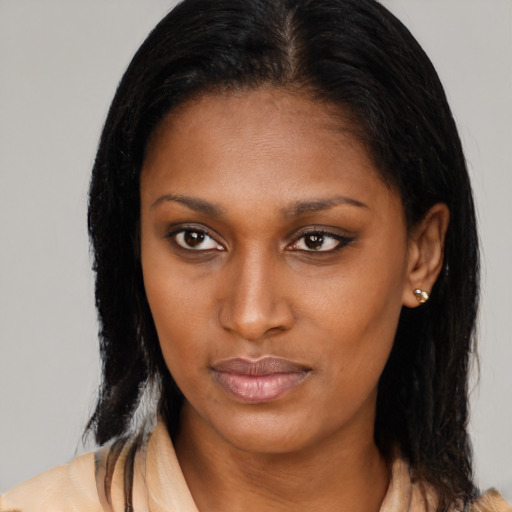 Joyful latino young-adult female with long  brown hair and brown eyes