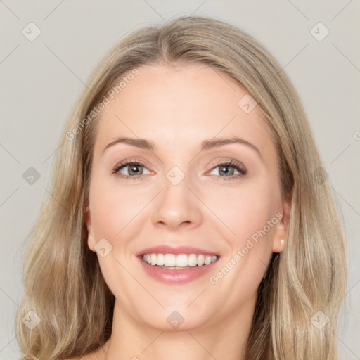 Joyful white young-adult female with long  brown hair and blue eyes