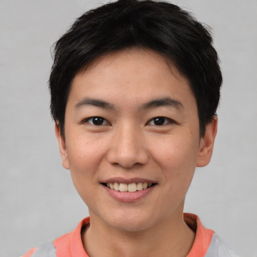 Joyful asian young-adult male with short  brown hair and brown eyes