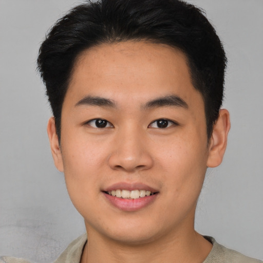 Joyful asian young-adult male with short  brown hair and brown eyes