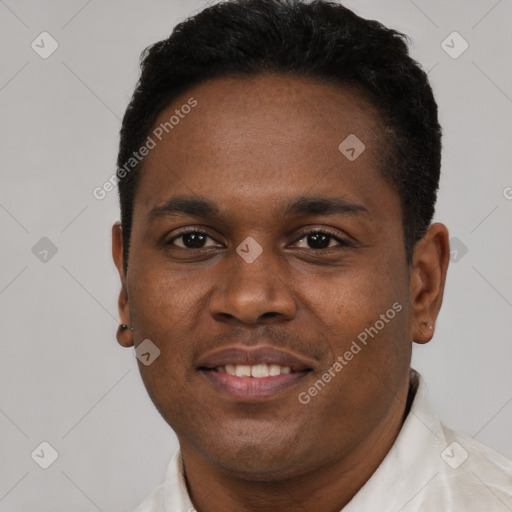 Joyful black young-adult male with short  black hair and brown eyes