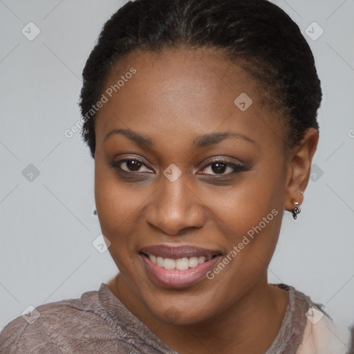 Joyful black young-adult female with short  brown hair and brown eyes