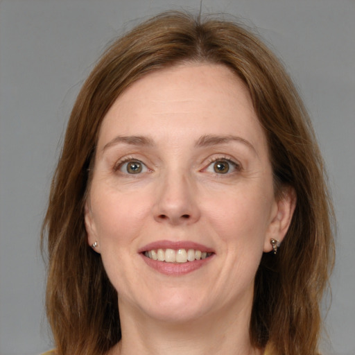 Joyful white adult female with medium  brown hair and grey eyes