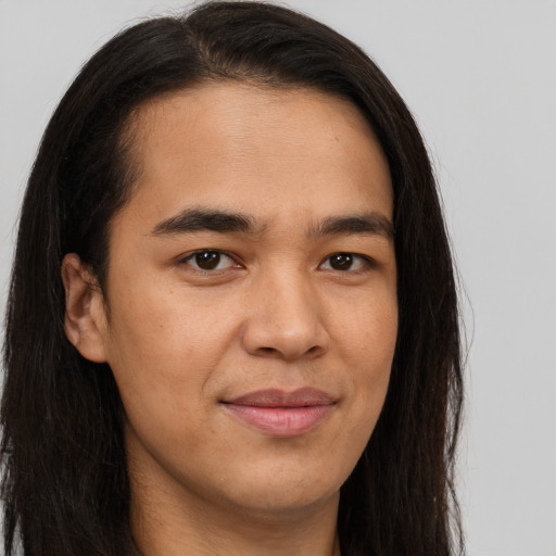 Joyful asian young-adult male with long  brown hair and brown eyes
