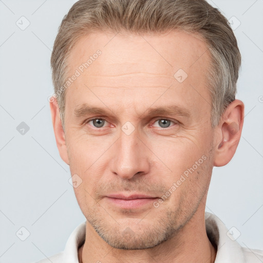 Joyful white adult male with short  brown hair and grey eyes