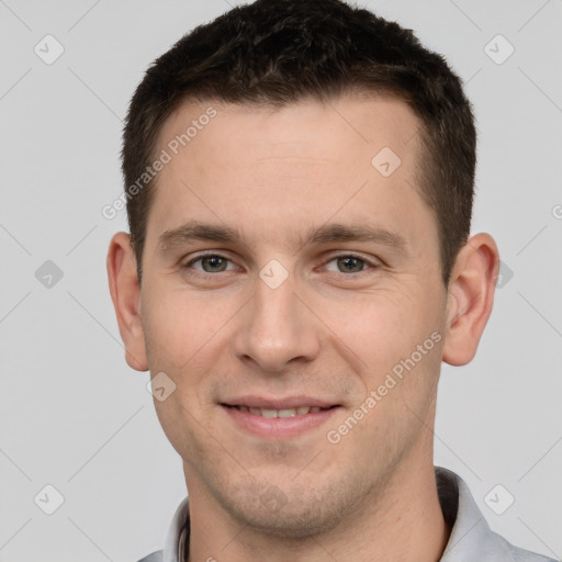 Joyful white young-adult male with short  brown hair and grey eyes