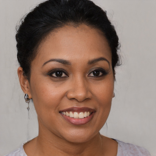 Joyful latino young-adult female with short  brown hair and brown eyes