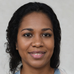 Joyful black young-adult female with medium  brown hair and brown eyes