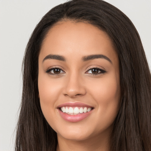 Joyful white young-adult female with long  black hair and brown eyes