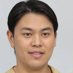 Joyful asian young-adult male with short  brown hair and brown eyes