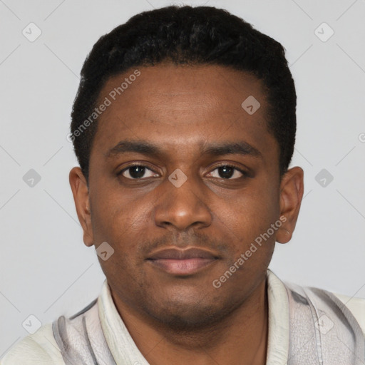 Joyful black young-adult male with short  black hair and brown eyes