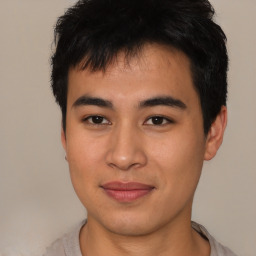 Joyful asian young-adult male with short  brown hair and brown eyes