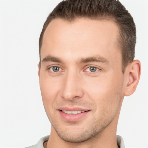 Joyful white young-adult male with short  brown hair and brown eyes