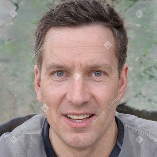 Joyful white adult male with short  brown hair and grey eyes