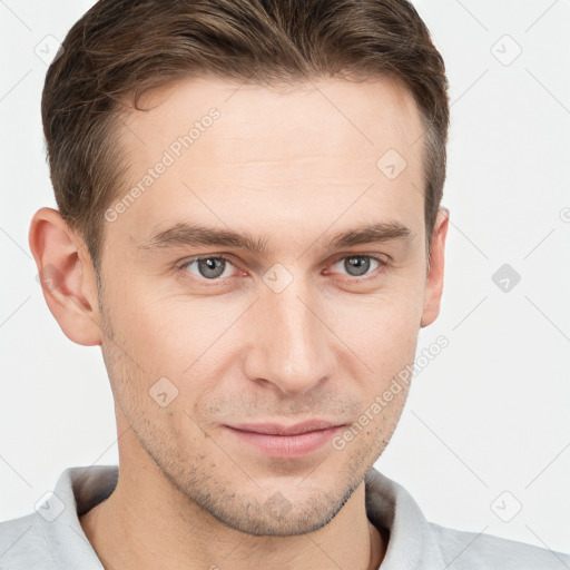 Joyful white young-adult male with short  brown hair and grey eyes