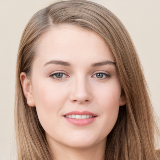 Joyful white young-adult female with long  brown hair and grey eyes