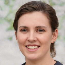 Joyful white young-adult female with medium  brown hair and grey eyes