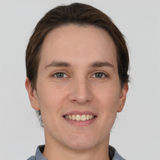 Joyful white adult male with short  brown hair and grey eyes